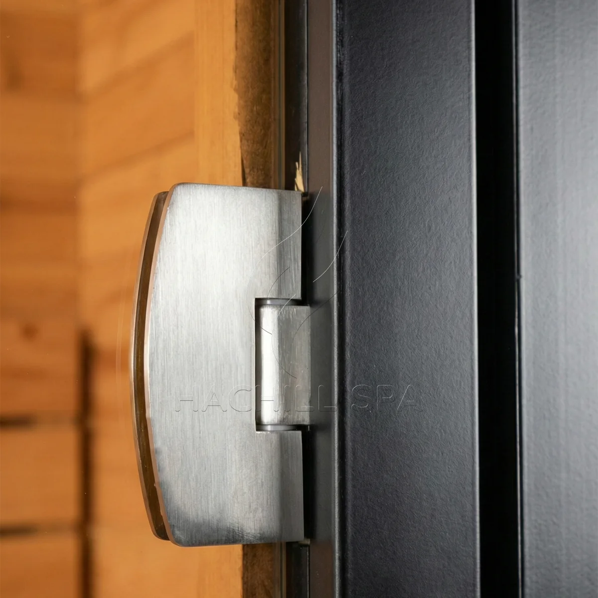 Close-up of the metal hinge and black door frame used on the CS04 cube sauna entry.