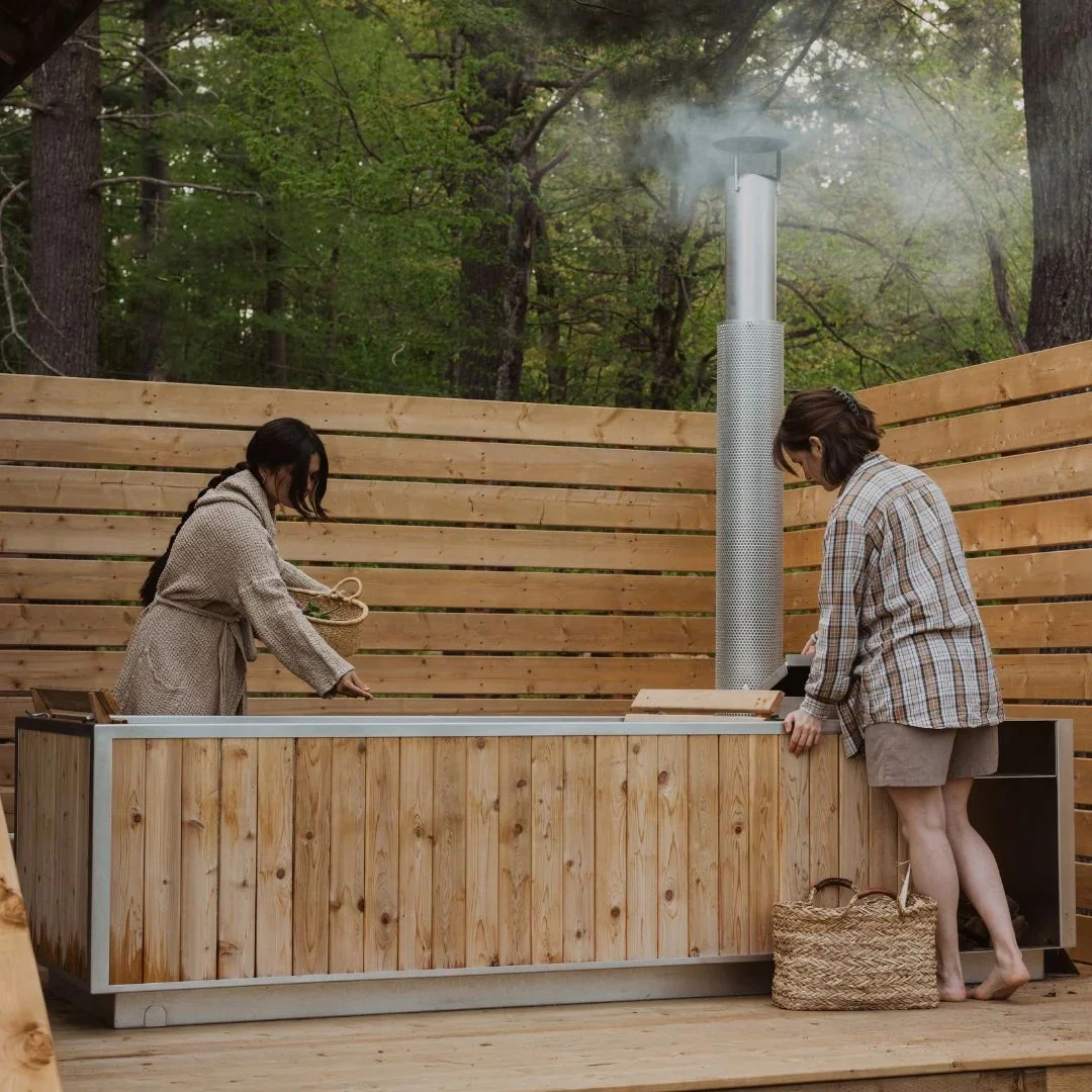 Family using a rectangular wood-fired hot tub