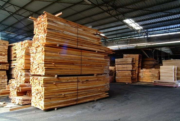 Stacked timber boards stored in a warehouse
