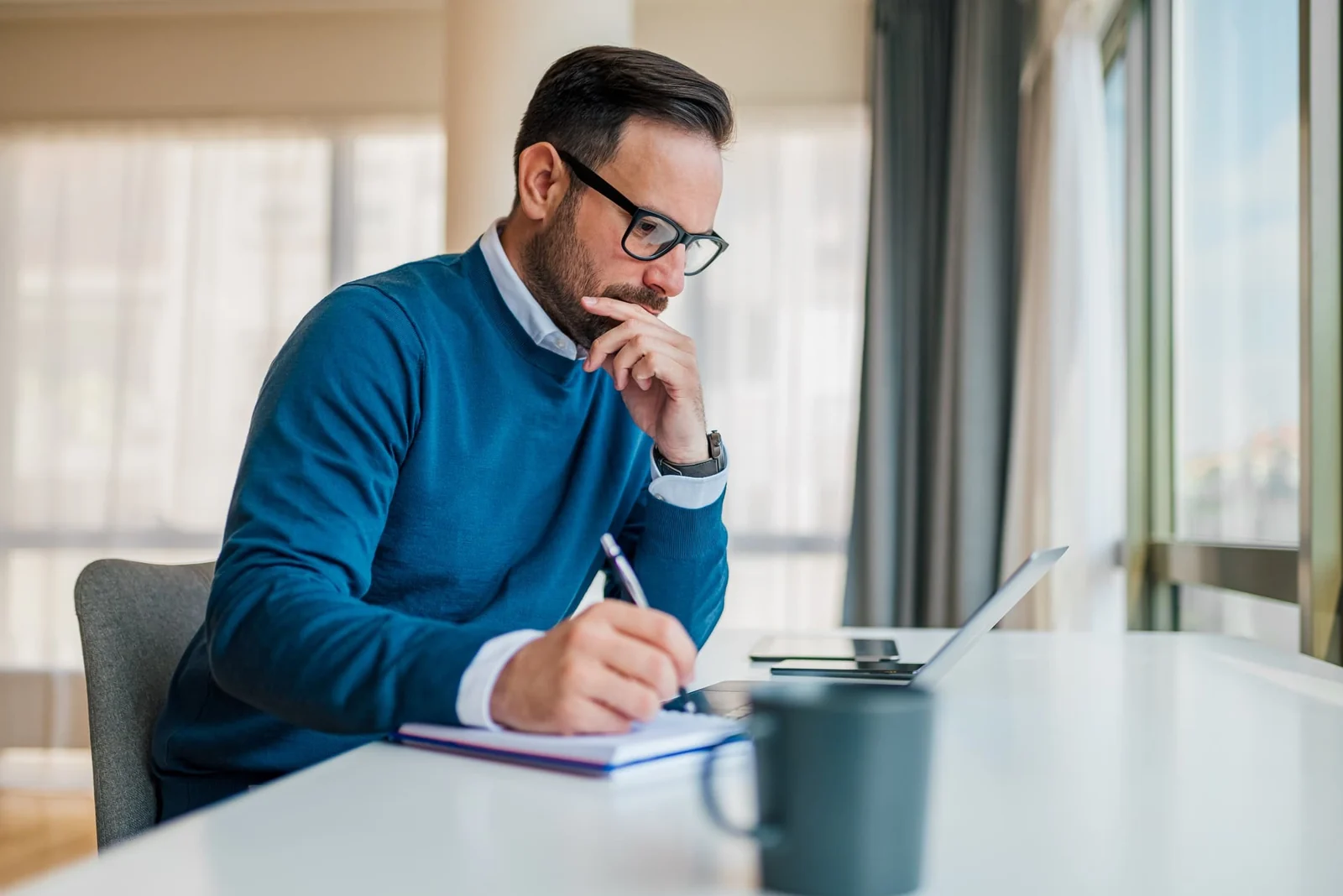 Project planner reviewing wellness equipment requirements at a desk