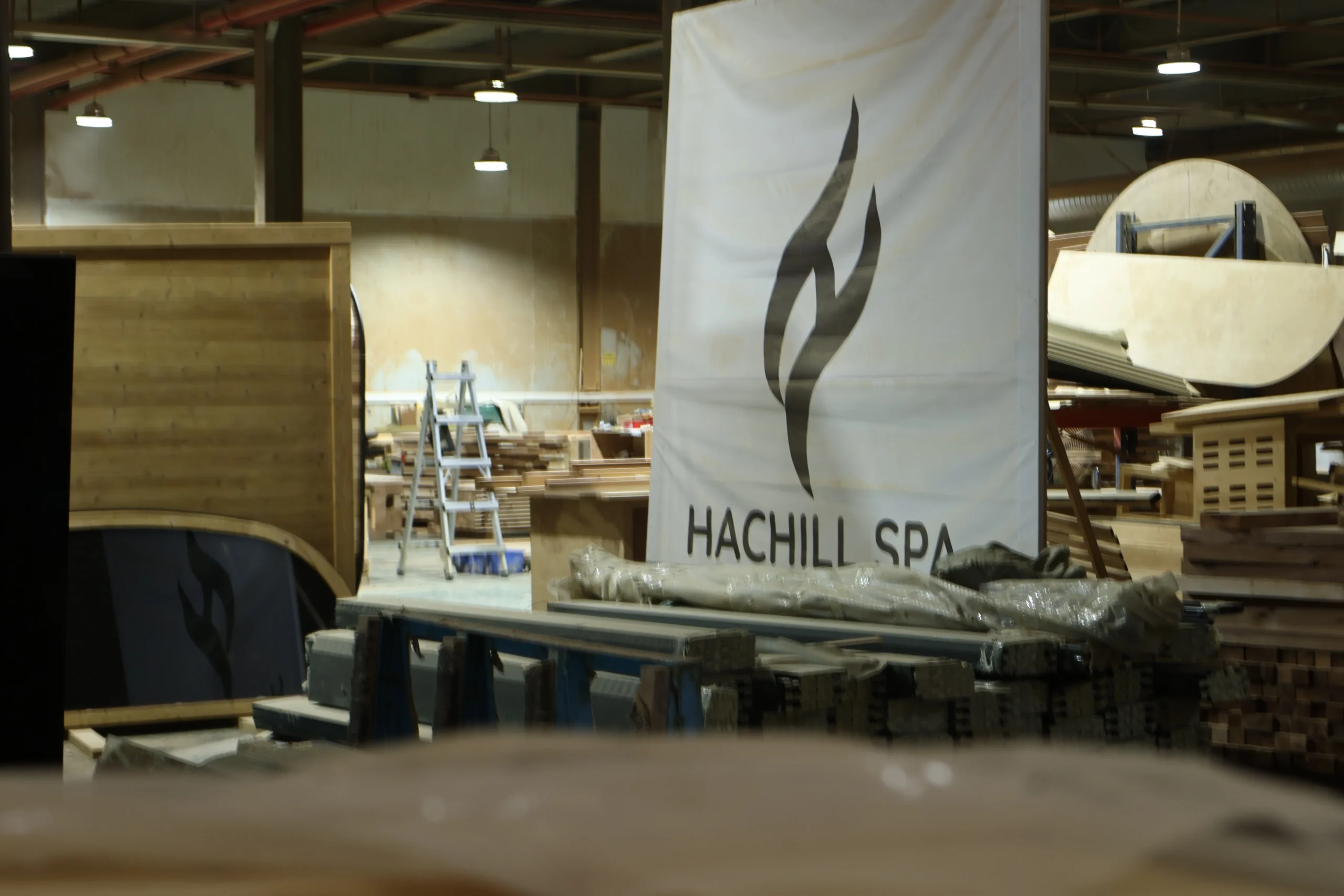 Commercial sauna and wellness products displayed beside the factory floor