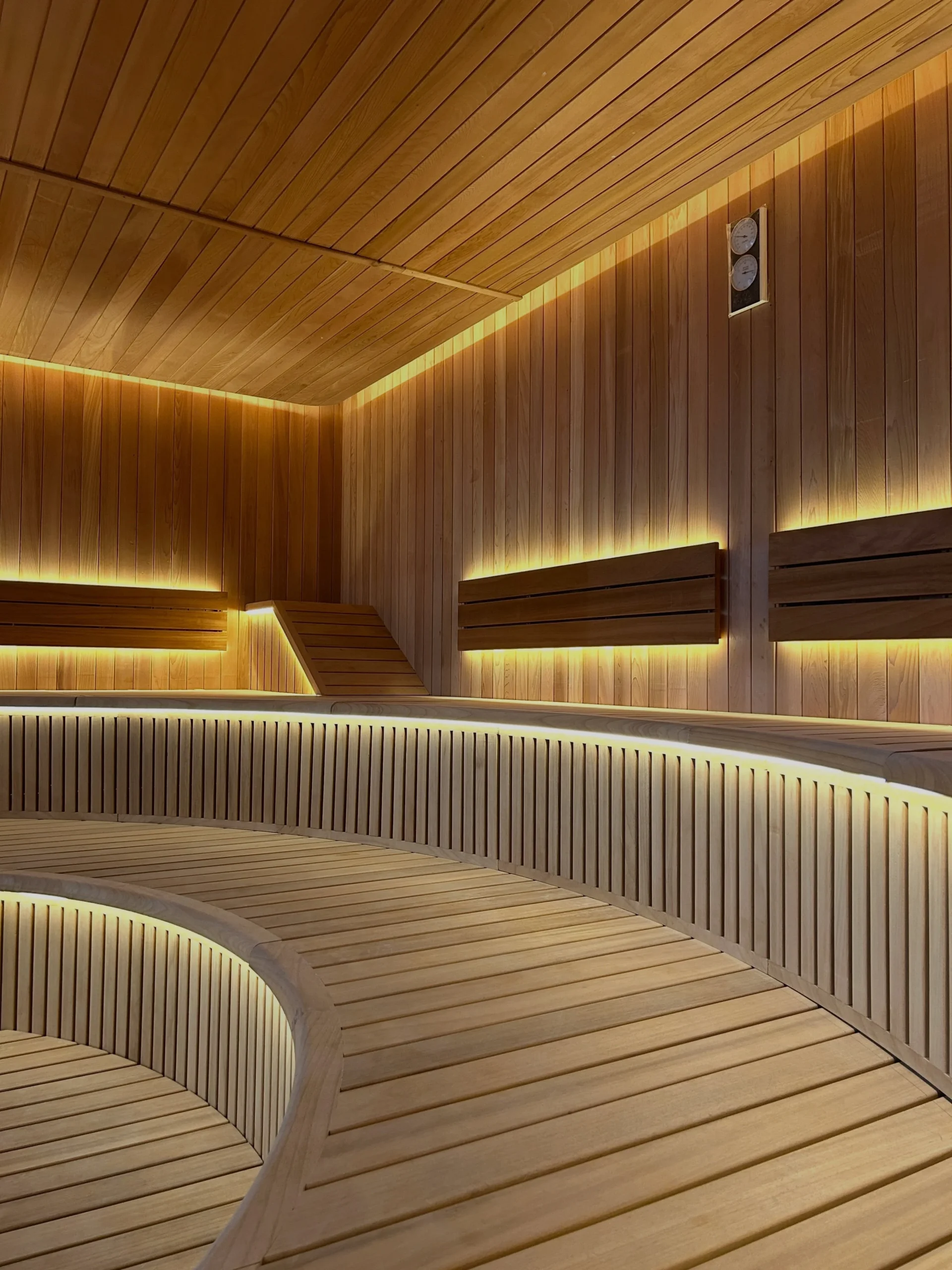 Custom curved sauna bench and glazing detail for architectural coordination