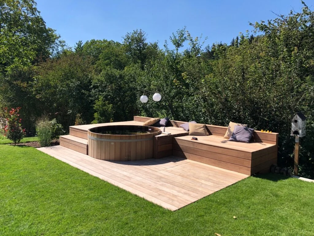 Outdoor wood-fired hot tub installed in a retail demonstration garden
