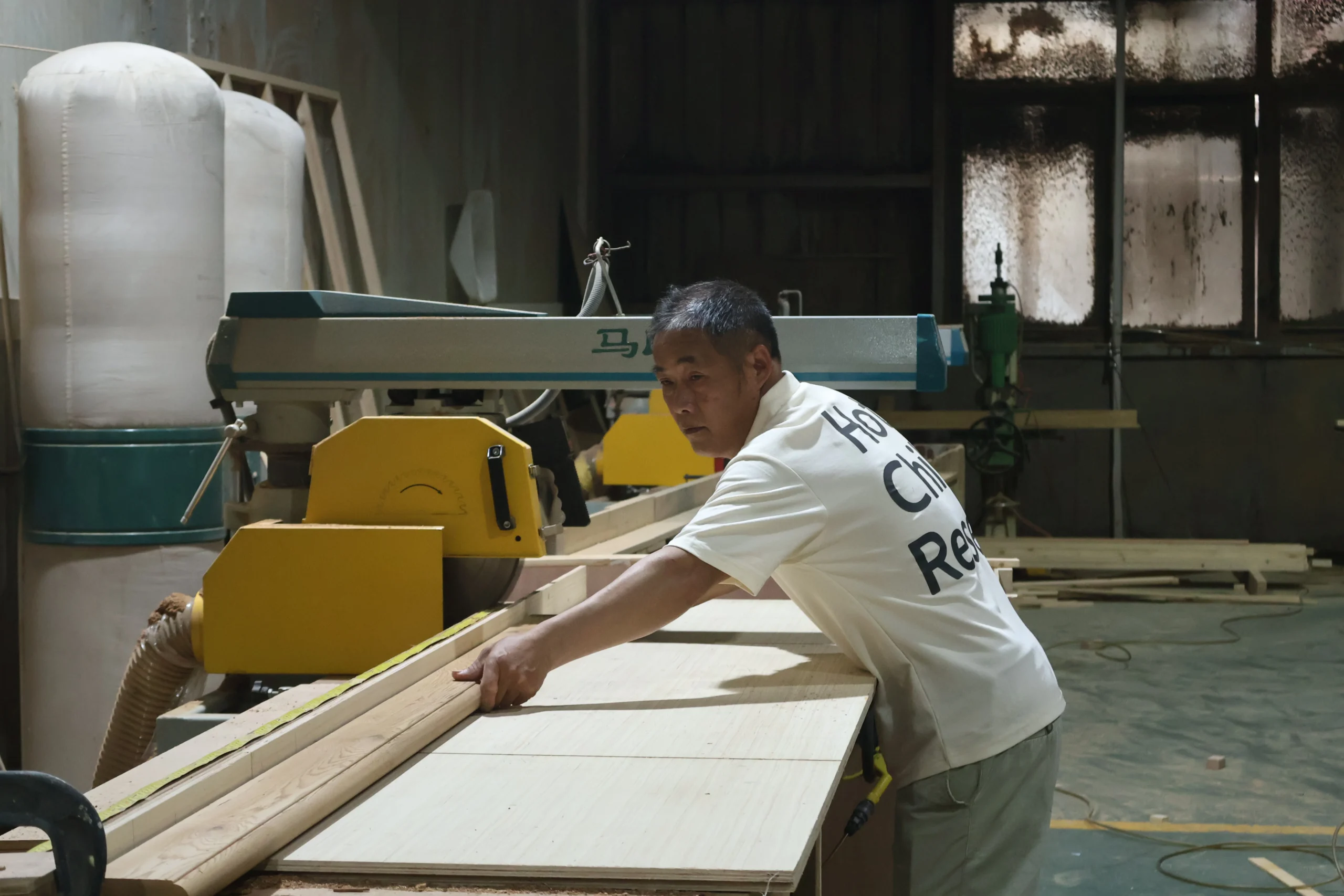 Craftsman finishing timber surfaces on a sauna component